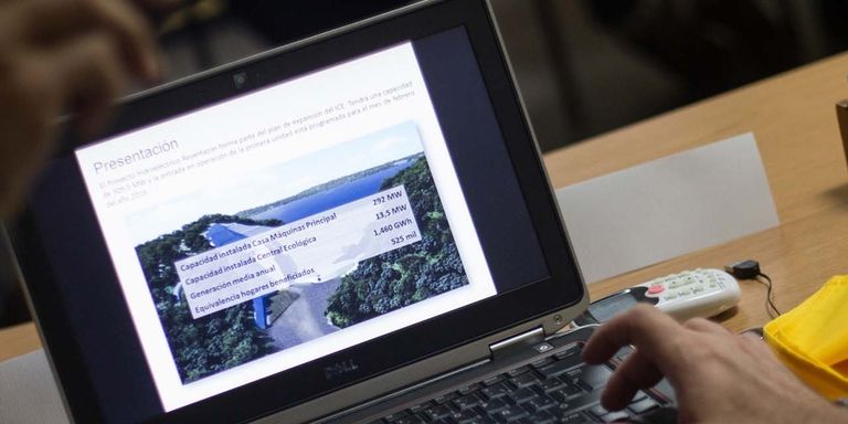 A person reviewing a presentation on a laptop
