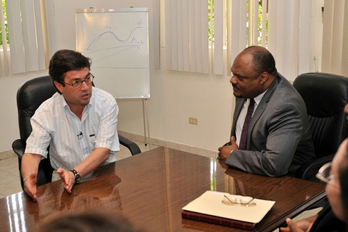 A group of men sitting at a table talking