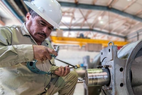 A person in a hard hat using a caliper. Equality - Inter-American Development Bank - IDB
