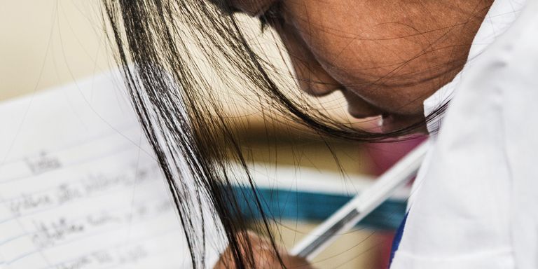 A girl is reading a notebook - Inter-American Development Bank - IDB
